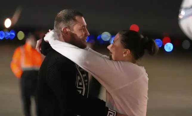 Ksenia Karelina greets her fiancé, professional boxer Chris van Heerden, as she arrives Thursday, April 10, 2025, at Joint Base Andrews, Md. (AP Photo/Alex Brandon)
