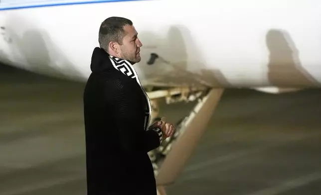 Ksenia Karelina's fiancé, professional boxer Chris van Heerden waits for her to exit the plane as she arrives Thursday, April 10, 2025, at Joint Base Andrews, Md. (AP Photo/Alex Brandon)
