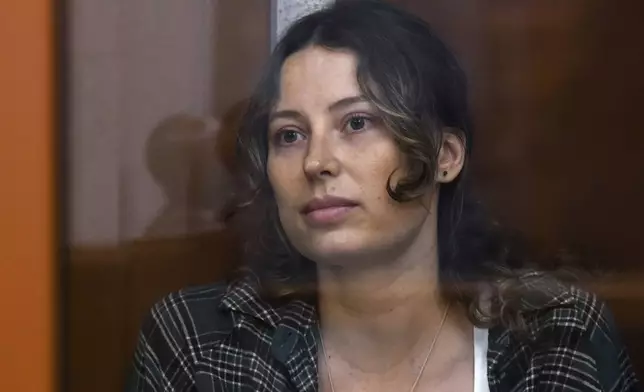 FILE - Ksenia Karelina, also known as Khavana sits in a glass cage in a court room in Yekaterinburg, Russia, Thursday, June 20, 2024. (AP Photo, File)