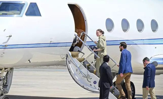 This photo released by the state-run WAM news agency shows U.S.-Russian dual national Ksenia Karelina getting on a private jet after her release at an airport in Abu Dhabi, United Arab Emirates, Thursday, April 10, 2025. (WAM via AP)