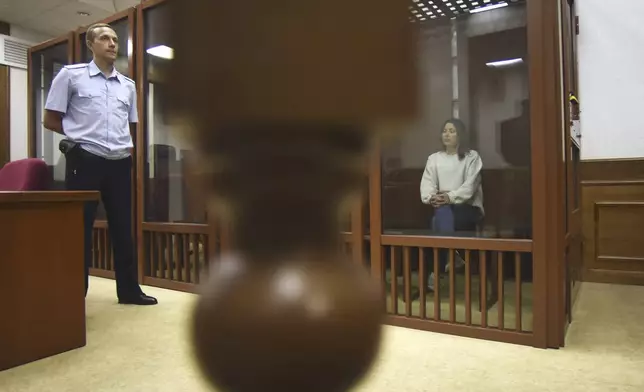 FILE - Ksenia Karelina sits in a glass cage in a court room in Yekaterinburg, Russia, Aug. 15, 2024. (AP Photo, File)