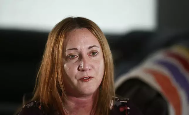 FILE - Lori Alhadeff, mother of 14-year-old Alyssa Alhadeff who was one of 17 people killed by a gunman who stalked the halls of Marjory Stoneman Douglas High School, cries while talking about her daughter on Wednesday, Jan. 30, 2019, in Parkland, Fla. (AP Photo/Brynn Anderson, File)