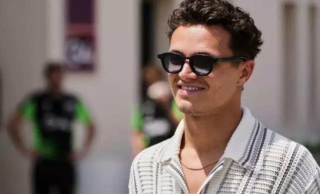 McLaren driver Lando Norris of Britain walks through the paddock ahead of the Formula One Bahrain Grand Prix at the Bahrain International Circuit in Sakhir, Thursday, April 10, 2025. (AP Photo/Darko Bandic)