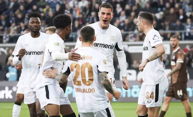 Leverkusen's Patrik Schick, center, celebrates scoring during the Bundesliga soccer match between FC St. Pauli and Bayer Leverkusen at Millerntor-Stadion, Hamburg, Germany, Sunday April 20, 2025. (Christian Charisius/dpa via AP)