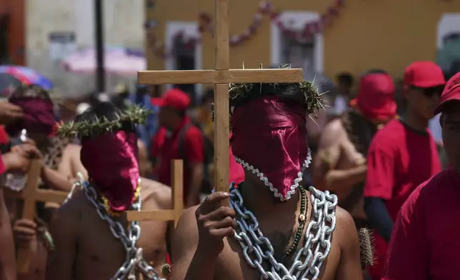 Masked penitents take part in a Holy Week procession in Atlixco, Mexico, on Good Friday, April 18, 2025. (AP Photo/Eduardo Verdugo)