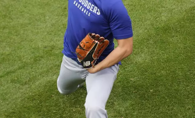 Los Angeles Dodgers' Shohei Ohtani (17) warms before a baseball game against the Chicago Cubs, Tuesday, April 22, 2025, in Chicago. (AP Photo/Erin Hooley)