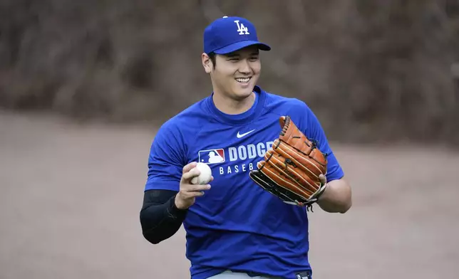 Los Angeles Dodgers' Shohei Ohtani (17) warms before a baseball game against the Chicago Cubs, Tuesday, April 22, 2025, in Chicago. (AP Photo/Erin Hooley)
