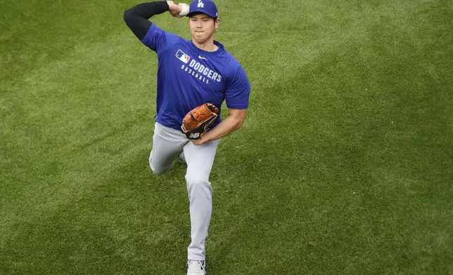 Los Angeles Dodgers' Shohei Ohtani (17) warms before a baseball game against the Chicago Cubs, Tuesday, April 22, 2025, in Chicago. (AP Photo/Erin Hooley)