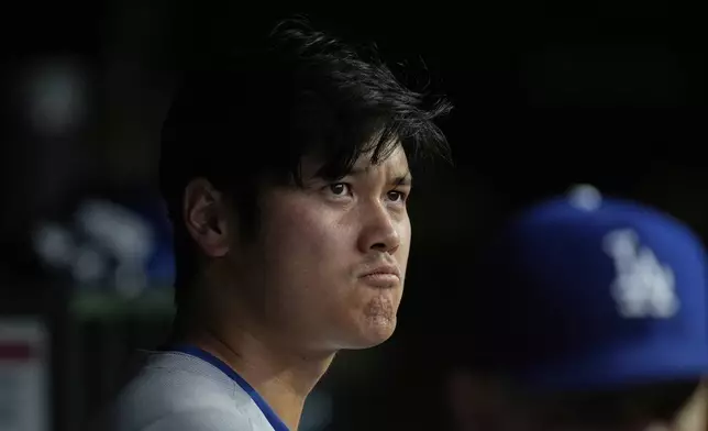 Los Angeles Dodgers designated hitter Shohei Ohtani (17) stands in the dugout during the first inning of a baseball game against the Chicago Cubs, Tuesday, April 22, 2025, in Chicago. (AP Photo/Erin Hooley)