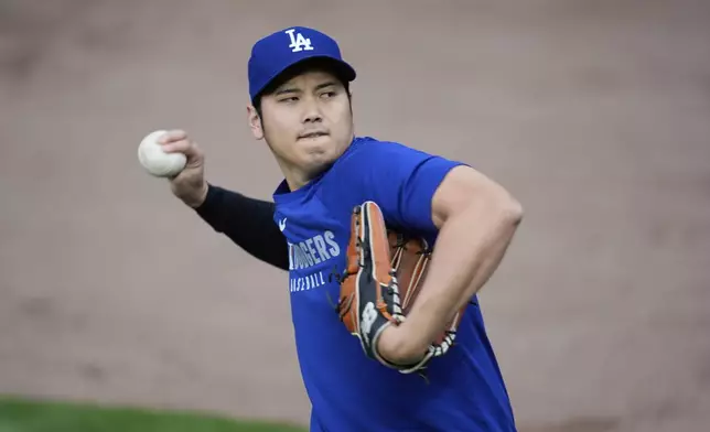 Los Angeles Dodgers' Shohei Ohtani (17) warms before a baseball game against the Chicago Cubs, Tuesday, April 22, 2025, in Chicago. (AP Photo/Erin Hooley)