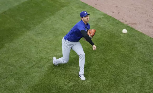 Los Angeles Dodgers' Shohei Ohtani (17) warms before a baseball game against the Chicago Cubs, Tuesday, April 22, 2025, in Chicago. (AP Photo/Erin Hooley)