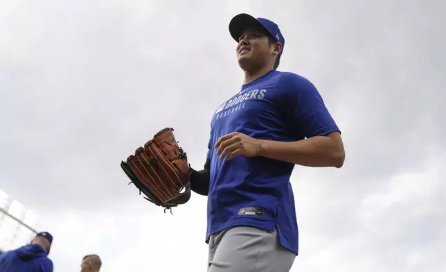 Los Angeles Dodgers' Shohei Ohtani (17) returns to the dugout before a baseball game against the Chicago Cubs, Tuesday, April 22, 2025, in Chicago. (AP Photo/Erin Hooley)