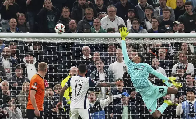 Frankfurt's goalkeeper Kaua Santos watches a shot from Tottenham's Pedro Porro hit the bar during the Europa League quarterfinals first leg soccer match between Tottenham Hotspur and Eintracht Frankfurt at the Tottenham Hotspur Stadium in London, England, Thursday, April 10, 2025. (AP Photo/Frank Augstein)