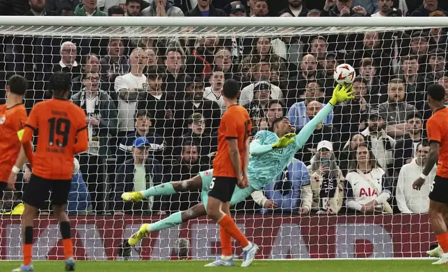 Frankfurt's goalkeeper Kaua Santos makes a save during the Europa League quarterfinals first leg soccer match between Tottenham Hotspur and Eintracht Frankfurt at the Tottenham Hotspur Stadium in London, England, Thursday, April 10, 2025. (AP Photo/Frank Augstein)