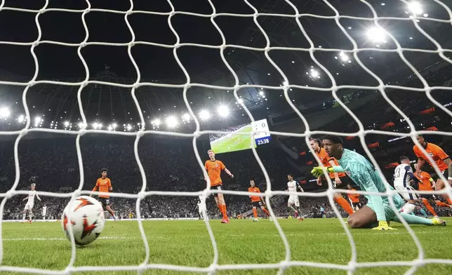 Frankfurt's goalkeeper Kaua Santos watches the ball cross the goal line after Tottenham's Pedro Porro scored his side's first goal during the Europa League quarterfinals first leg soccer match between Tottenham Hotspur and Eintracht Frankfurt at the Tottenham Hotspur Stadium in London, England, Thursday, April 10, 2025. (AP Photo/Frank Augstein)