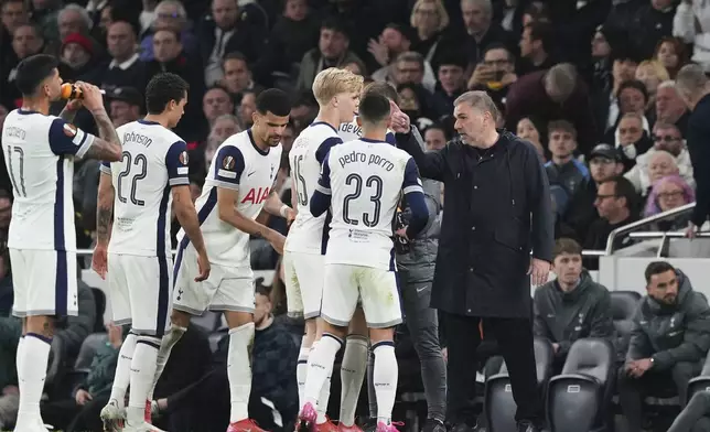 Tottenham's head coach Ange Postecoglou speaks to the players during the Europa League quarterfinals first leg soccer match between Tottenham Hotspur and Eintracht Frankfurt at the Tottenham Hotspur Stadium in London, England, Thursday, April 10, 2025. (AP Photo/Frank Augstein)