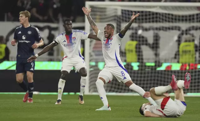 Lyon's Corentin Tolisso, centre right, reacts during the Europa League quarterfinal first leg soccer match between Lyon and Manchester United at Groupama stadium in Decines, outside Lyon, France, Thursday, April 10, 2025. (AP Photo/Thibault Camus)