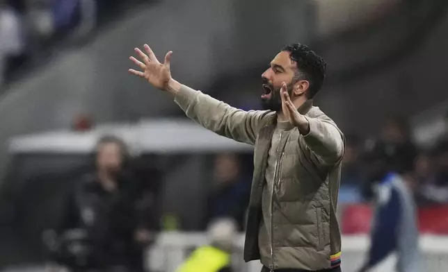 Manchester United's head coach Ruben Amorim gestures during the Europa League quarterfinal first leg soccer match between Lyon and Manchester United at Groupama stadium in Decines, outside Lyon, France, Thursday, April 10, 2025. (AP Photo/Thibault Camus)