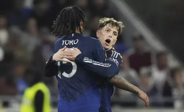 Manchester United's Leny Yoro, left, celebrates with Alejandro Garnacho after scoring his side's first goal during the Europa League quarterfinal first leg soccer match between Lyon and Manchester United at Groupama stadium in Decines, outside Lyon, France, Thursday, April 10, 2025. (AP Photo/Thibault Camus)