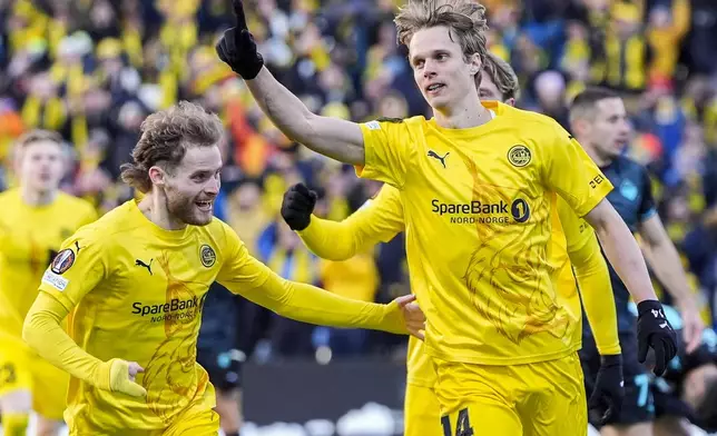 Bodø/Glimt's Ulrik Saltnes, right, celebrates after scoring the opening goal during the Europa League quarterfinal soccer match between Bodø/Glimt and Lazio at Aspmyra Stadium in Bodø, Norway, Thursday, April 10, 2025. (Lise Åserud/NTB via AP)
