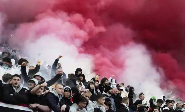 Legia's fans use flares during the Europa Conference League first-leg quarterfinals soccer match between Legia Warszawa and Chelsea at the Marshall Jozef Pilsudski's Municipal stadium in Warsaw, Poland, Thursday, April 10, 2025. (AP Photo/Czarek Sokolowski)
