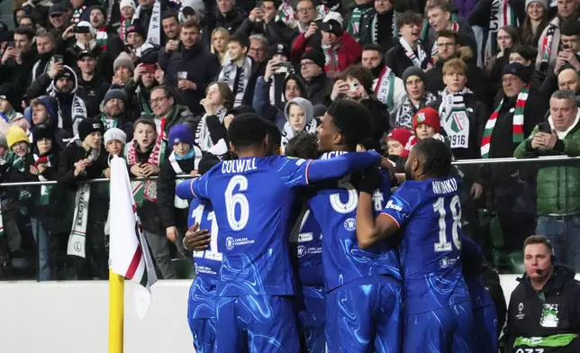 Chelsea players celebrate a goal against Legia during the Europa Conference League first-leg quarterfinals soccer match between Legia Warszawa and Chelsea at the Marshall Jozef Pilsudski's Municipal stadium in Warsaw, Poland, Thursday, April 10, 2025. (AP Photo/Czarek Sokolowski)