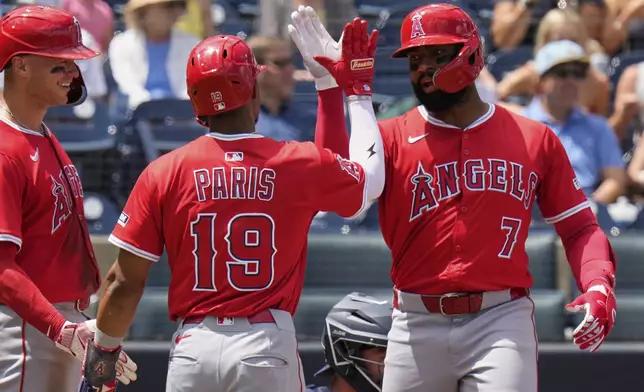 Los Angeles Angels' Jo Adell (7) celebrates his three run home run off Tampa Bay Rays pitcher Mason Englert with Kyren Paris (19) and Logan O'Hoppe during the fifth inning of a baseball game Thursday, April 10, 2025, in Tampa, Fla. (AP Photo/Chris O'Meara)