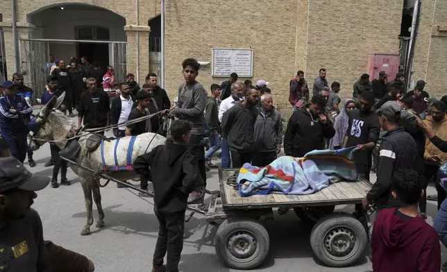 Palestinians carry the bodies of their relatives who were killed in an Israeli airstrike in Shijaiyah neighborhood, as they brought to the Baptist Hospital in Gaza City on Wednesday, April 9, 2025. (AP Photo/Jehad Alshrafi)