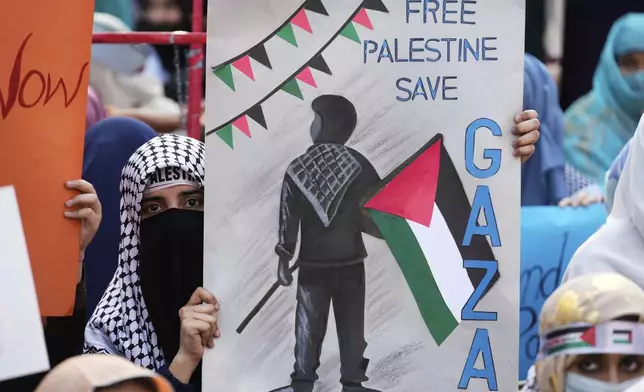 Supporters of the Pakistani religious group "Jamaat-e-Islami" take part in a rally against Israeli airstrikes and to show solidarity with Palestinian people living in Gaza, in Lahore, Pakistan Friday, April 11, 2025. (AP Photo/K.M. Chaudary)