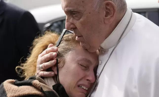 FILE - Pope Francis consoles Serena Subania who lost her daughter Angelica, 5 years old, the day before as he leaves the Agostino Gemelli University Hospital after receiving treatment for a bronchitis, in Rome, Saturday, April 1, 2023. (AP Photo/Gregorio Borgia, file)