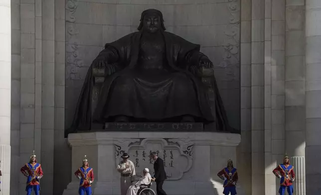 FILE - Mongolian President Ukhnaagiin Khurelsukh, left, and Pope Francis meet, Saturday, Sept. 2, 2023, in front of a gigantic statue of former Khagan of the Mongol Empire Genghis Khan in Sukhbaatar Square in Ulaanbaatar. (AP Photo/Ng Han Guan, File)