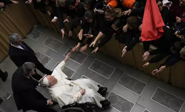 FILE - Pope Francis leaves after an audience with "Pueri Cantores", the official student Catholic choral organization, in the Paul VI Hall, at the Vatican, Saturday, Dec. 30, 2023. (AP Photo/Alessandra Tarantino, file)