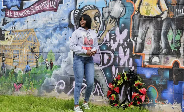 Fredricka Gray, twin sister of Freddie Gray, lays a wreath at a mural during a memorial event commemorating the ten-year anniversary of her brother's death, Saturday, April 19, 2025, in Baltimore. (AP Photo/Stephanie Scarbrough)