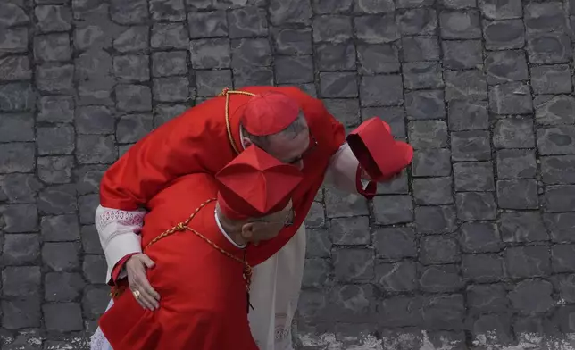 Prelates walk at St. Peter's Square ahead of the arrival of the body of Pope Francis, who will lie in state at St. Peter's Basilica for three days, at the Vatican, Wednesday, April 23, 2025. (AP Photo/Gregorio Borgia)