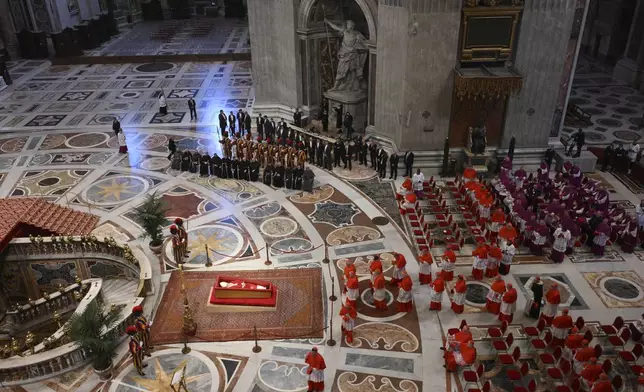 The body of Pope Francis is carried into St. Peter's Basilica at the Vatican, Wednesday, April 23, 2025, where he will lie in state for three days. (Alessandro Di Meo/ Pool Photo via AP)