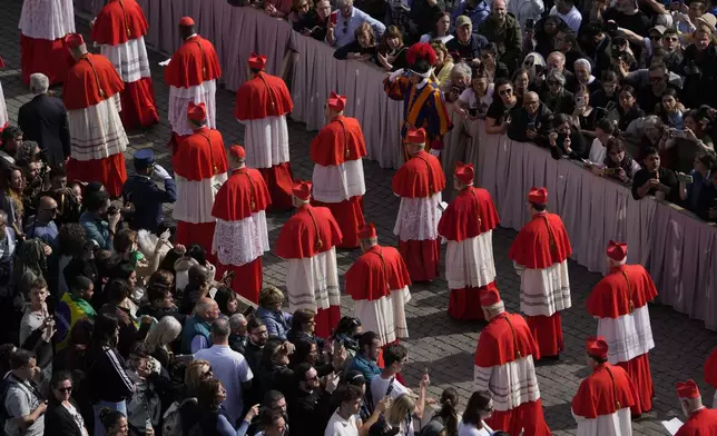 Cardinals take part in the ceremony transfering Pope Francis' body, who will lie in state at St. Peter's Basilica for three days, at the Vatican, Wednesday, April 23, 2025. (AP Photo/Gregorio Borgia)