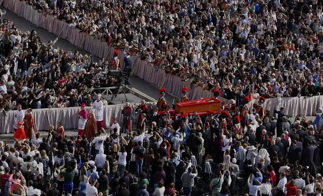 The body of Pope Francis is carried through St. Peter's Square to St. Peter's Basilica at the Vatican, Wednesday, April 23, 2025, where he will lie in state for three days. (Cecilia Fabiano/ Lapresse via AP)