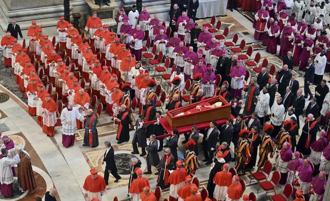 The body of Pope Francis is carried into St. Peter's Basilica at the Vatican, Wednesday, April 23, 2025, where he will lie in state for three days. (Alessandro Di Meo/ Pool Photo via AP)