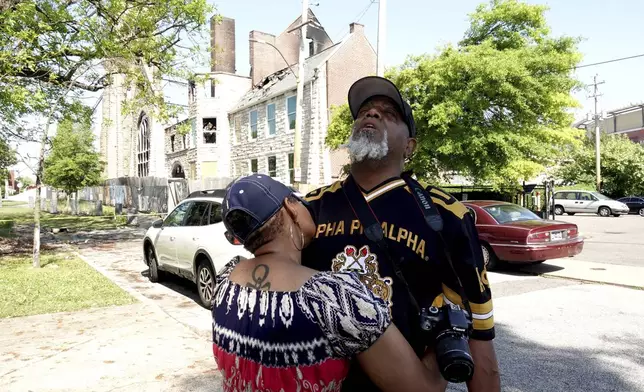 Sadyya Rockett-Miller and her husband Andre LeMoyne Miller grieve outside of the historic Clayborn Temple, a landmark from the civil rights movement with ties to Martin Luther King, that caught fire Monday, April 28, 2025, in Memphis, Tenn. (AP Photo/Karen Pulfer Focht)