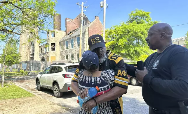 Sadyya Rockett-Miller and her husband Andre LeMoyne Miller grieve outside of the historic Clayborn Temple, a landmark from the civil rights movement with ties to Martin Luther King, that caught fire Monday, April 28, 2025, in Memphis, Tenn. (AP Photo/Karen Pulfer Focht)