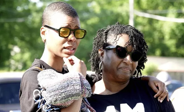 Talibah Safiya and Tamika Turner grieve outside the historic Clayborn Temple, a landmark from the civil rights movement with ties to Martin Luther King, that caught fire Monday, April 28, 2025, in Memphis, Tenn. (AP Photo/Karen Pulfer Focht)