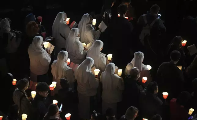 Nuns attend the procession outside the Colosseum during the Via Crucis (Latin for 'way of the cross') in Rome, Friday, April 18, 2025. (AP Photo/Andrew Medichini)