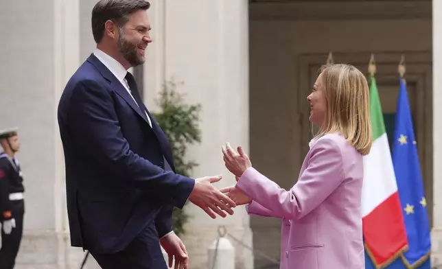 U.S. Vice President JD Vance, left, is welcomed by Italian Premier Giorgia Meloni as he arrives for talks at Palazzo Chigi government office in Rome, Friday, April 18, 2025. (AP Photo/Andrew Medichini)
