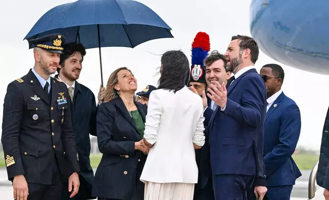 U.S. Vice President JD Vance, second right, is greeted by Italian government officials upon arriving at G.B. Pastine–Rome Ciampino Airport, Friday April 18, 2025. (Kenny Holston/The New York Times via AP, Pool)