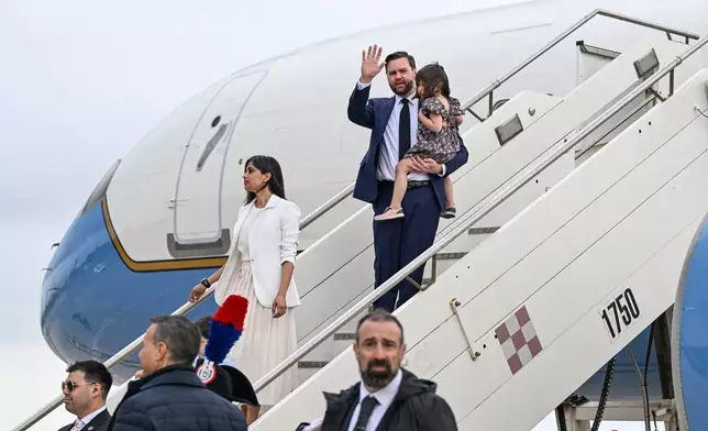 Vice President JD Vance, carrying their daughter Mirabel and Second Lady Usha Vance disembark Air Force Two upon arriving at G.B. Pastine–Rome Ciampino Airport, Friday April 18, 2025. (Kenny Holston/The New York Times via AP, Pool)