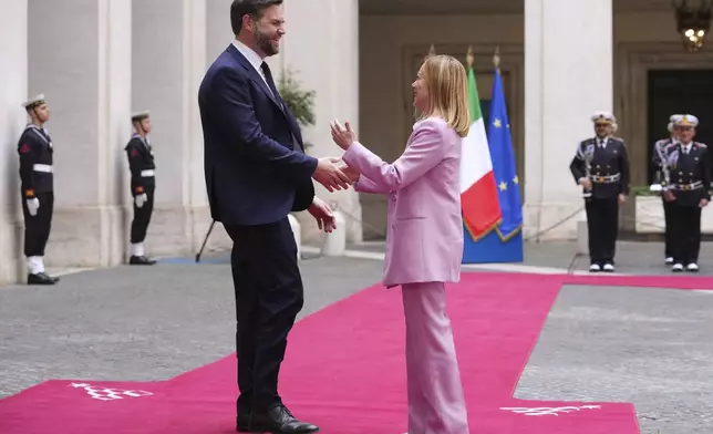 U.S. Vice President JD Vance, left, is welcomed by Italian Premier Giorgia Meloni as he arrives for talks at Palazzo Chigi government office in Rome, Friday, April 18, 2025. (AP Photo/Andrew Medichini)