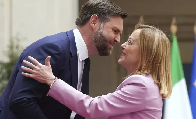 U.S. Vice President JD Vance, left, is welcomed by Italian Premier Giorgia Meloni as he arrives for talks at Palazzo Chigi government office in Rome, Friday, April 18, 2025. (AP Photo/Andrew Medichini)