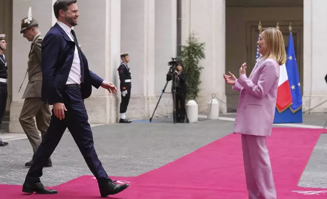 U.S. Vice President JD Vance, left, is welcomed by Italian Premier Giorgia Meloni as he arrives for talks at Palazzo Chigi government office in Rome, Friday, April 18, 2025. (AP Photo/Andrew Medichini)