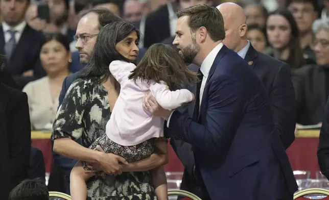 U.S. Vice President JD Vance, his wife Usha Vance, left, arrive with their daughter Mirabel, back to camera for a Good Friday service inside St. Peter's Basilica at the Vatican, Friday, April 18, 2025. (AP Photo/Alessandra Tarantino)