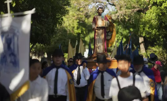 Parishioners carry a religious float with a statue of St. Mark during a month-long event honoring the saint, outside St. Mark's church in Aguascalientes, Mexico, Friday, April 25, 2025. (AP Photo/Eduardo Verdugo)